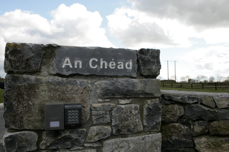 House sign incorporated in the natural stone wall.