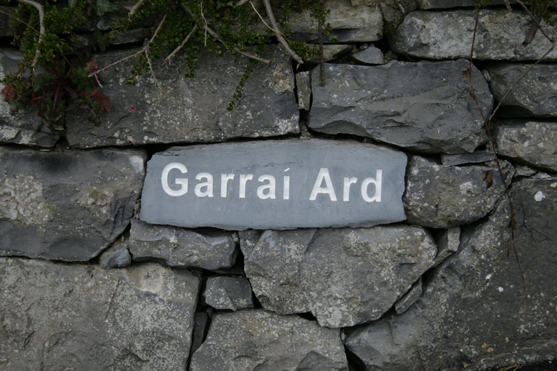 House sign incorporated in the natural stone wall.