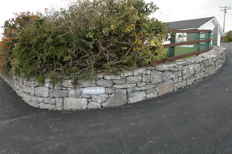 House sign incorporated in the natural stone wall.