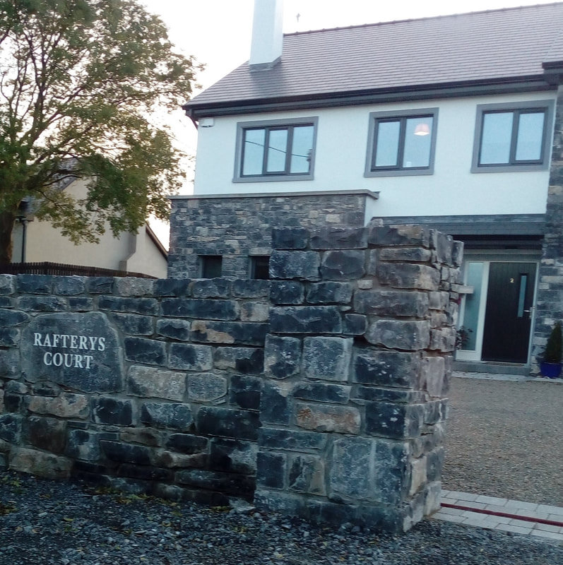 House sign incorporated in the natural stone wall.