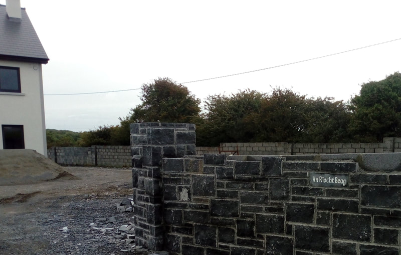 House sign incorporated in the natural stone wall.