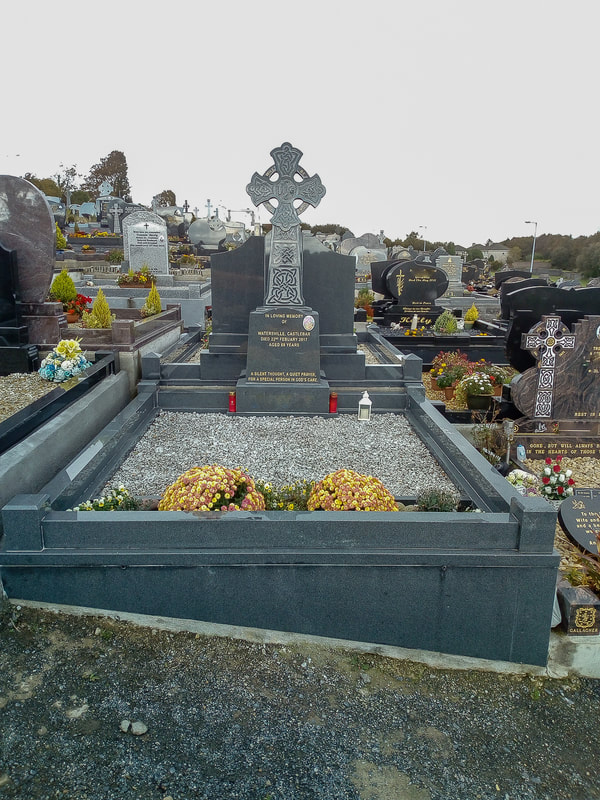 Light grey polished granite Celtic cross headstone with Celtic engravings throughout, with matching kerbing.