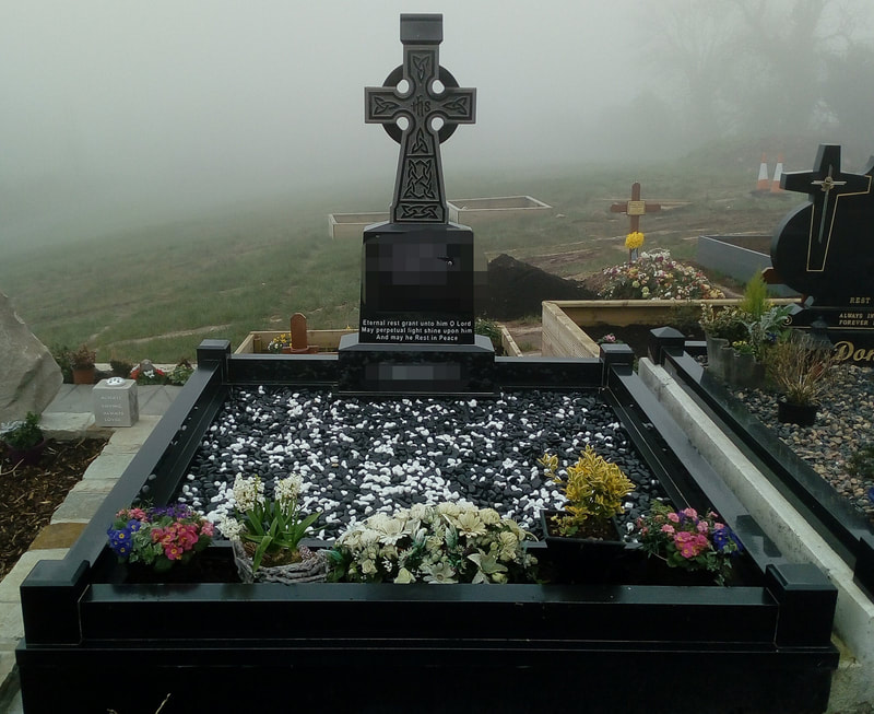 Black polished granite Celtic cross headstone with Celtic engravings throughout, with matching kerbing.