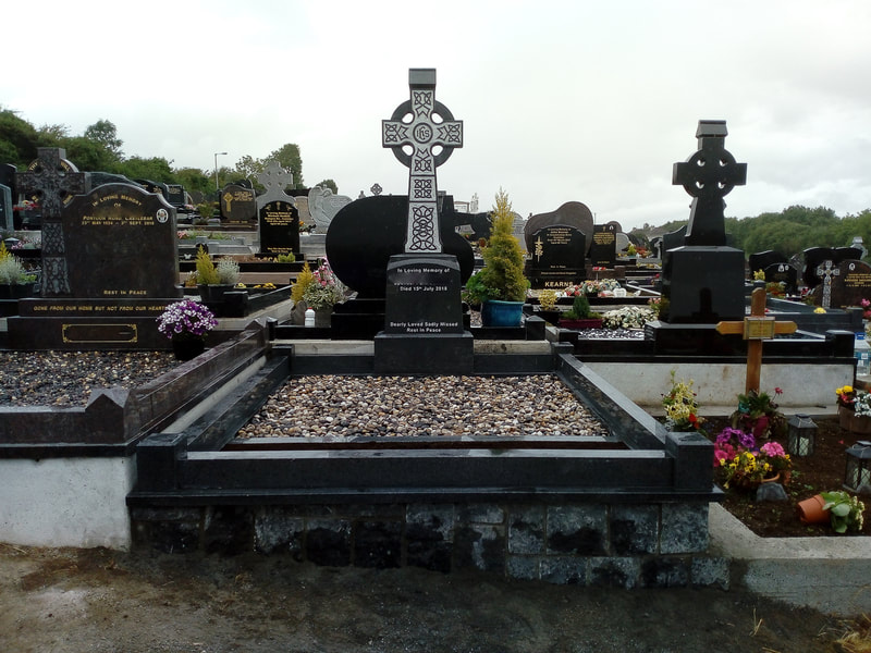 Light grey polished granite Celtic cross headstone with Celtic engravings throughout, with matching kerbing.