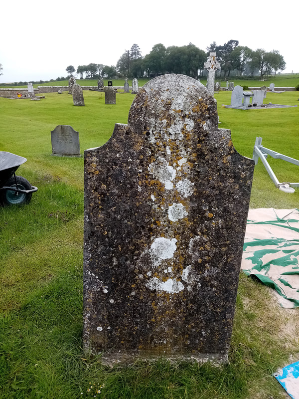 Before picture of cross headstone before restoration.